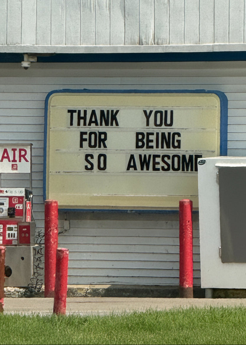 Turquoise fire hydrant in front of a building with a sign saying 'Thank you for being so awesome'.